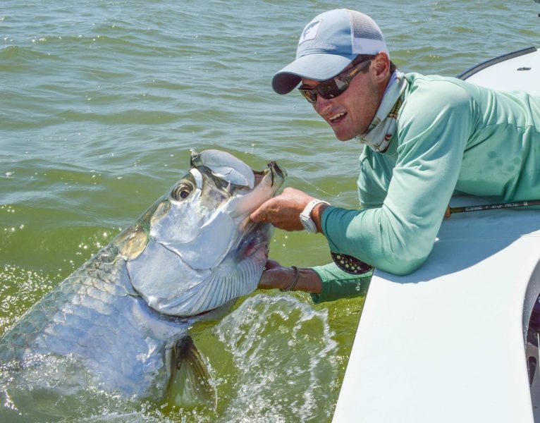 A fisherman holding the head of a large Homosassa Tarpon