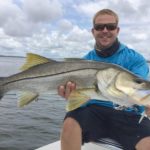 A fisherman holding a alarge snook caught on a Homosassa fishing trip.