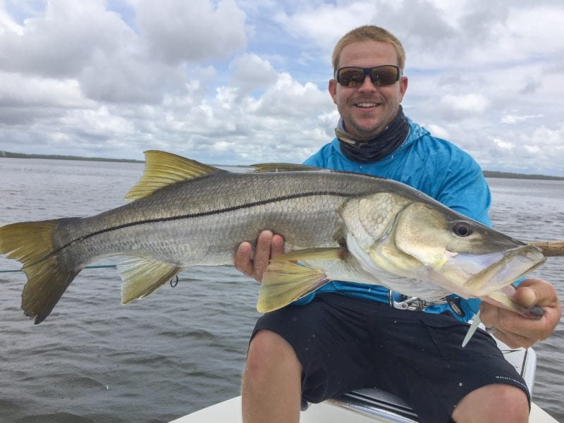 A fisherman holding a alarge snook caught on a Homosassa fishing trip.