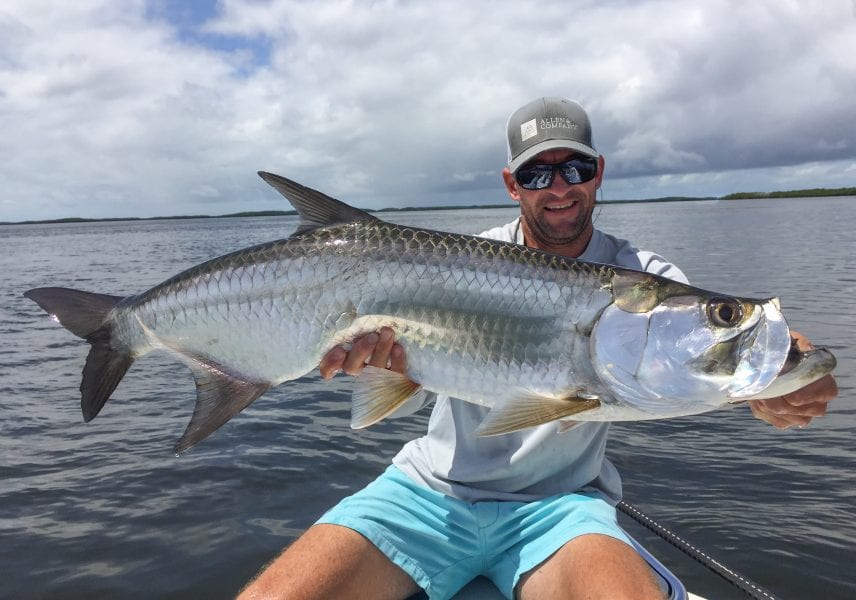 A great sized tarpon being held up by a fisherman in homosassa